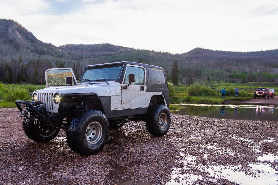Jeep Wrangler driving on a dirt road off-road trail